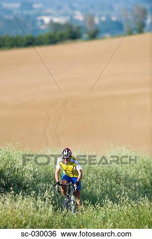Cyclist riding bicycle, front view View Large Photo Image Stock Photograph - Cyclist riding bicycle, front view. Fotosearch