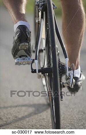 Stock Photo - Detail of a cyclist pedaling. Fotosearch