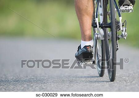 Stock Photo - Detail of a cyclist pedaling. Fotosearch