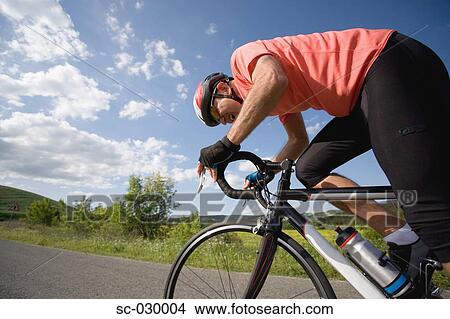 Picture - Road cyclist in action, side view. Fotosearch