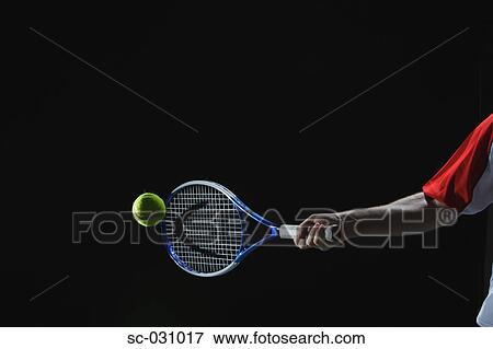 Stock Photo - Tennis Player Swinging at Ball. Fotosearch