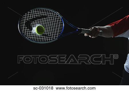 Stock Photo - Tennis Player Swinging at Ball. Fotosearch