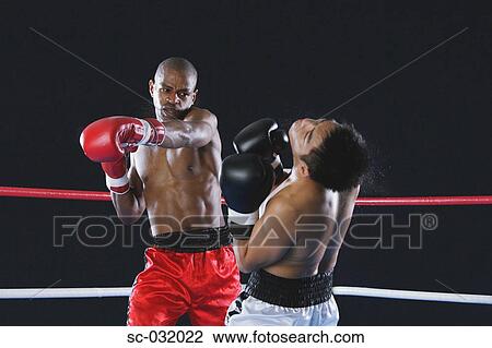 Stock Image - African boxer hitting his opponent. Fotosearch