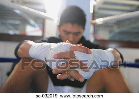 Stock Photo - Boxer wearing bandage in his both hands. Fotosearch