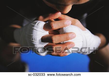 Stock Image - Boxer's hands and knuckles tied with bandage. Fotosearch