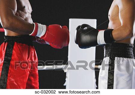 Stock Image - Two boxers wearing Boxing gloves. Fotosearch