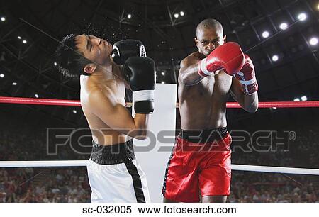 Stock Photography - Two men Boxing with one being hit. Fotosearch