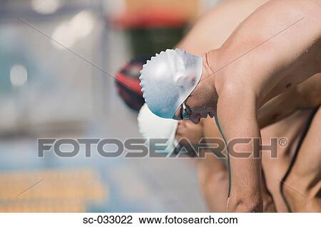 Stock Image - Australian swimmers lined up at starting line. Fotosearch