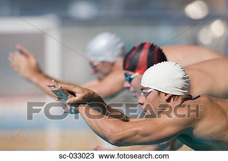 Stock Image - Australian swimmers lined up at starting line. Fotosearch
