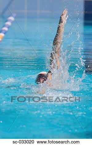 Stock Image - Young australian athlete doing backstroke. Fotosearch