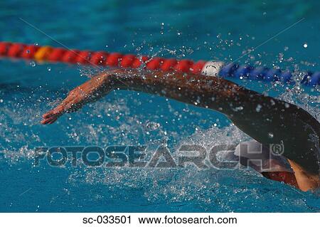 Stock Image - Young Australian swimmer doing butterfly stroke. Fotosearch