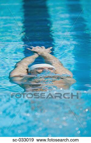 Stock Photo - Young swimmer doing backstroke underwater. Fotosearch