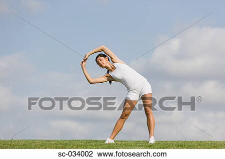 Woman Exercising and stretching arms View Large Photo Image Stock Image - Woman Exercising and stretching arms. Fotosearch
