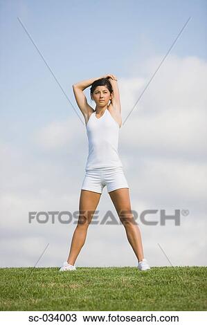 Woman Exercising and stretching arms View Large Photo Image Stock Image - Woman Exercising and stretching arms. Fotosearch