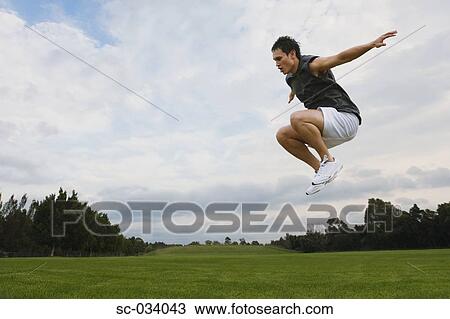 Young man jumping in the air View Large Photo Image Stock Image - Young man jumping in the air. Fotosearch