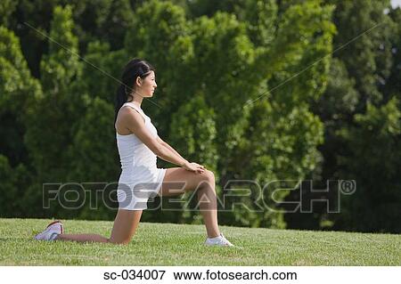 Stock Photo - Young Woman in Low Lunge position of yoga. Fotosearch
