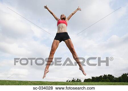 Young Woman jumping in the air View Large Photo Image Stock Photo - Young Woman jumping in the air. Fotosearch