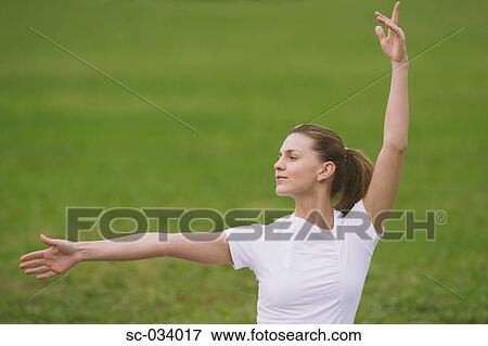 Stock Photo - Young Woman Widely Stretching Arms. Fotosearch