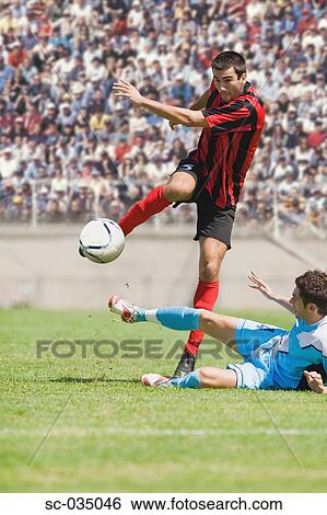 Stock Photograph - Soccer player avoiding a tackle. Fotosearch