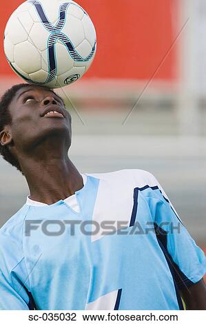 Soccer player juggling ball on head View Large Photo Image Stock Image - Soccer player juggling ball on head. Fotosearch