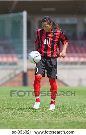 Stock Image - Soccer player juggling with ball. Fotosearch