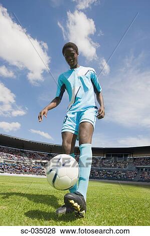 Stock Photo - Soccer player juggling with ball. Fotosearch
