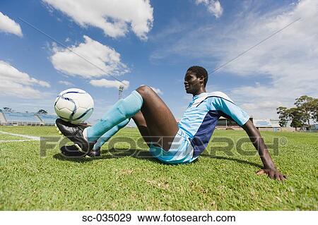 Stock Photo - Soccer player juggling with ball. Fotosearch