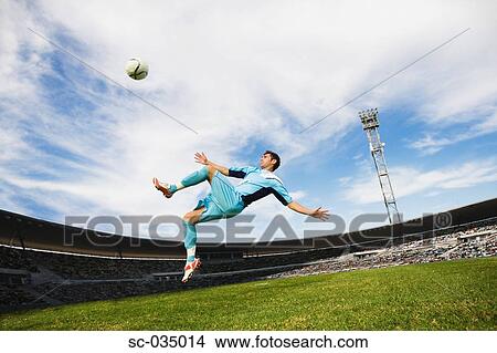 Soccer player performing aerial kick View Large Photo Image Picture - Soccer player performing aerial kick. Fotosearch