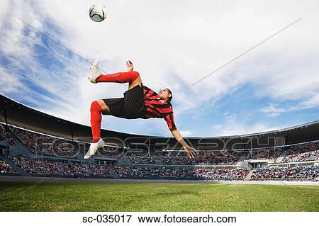 Soccer player performing aerial kick View Large Photo Image Stock Photo - Soccer player performing aerial kick. Fotosearch