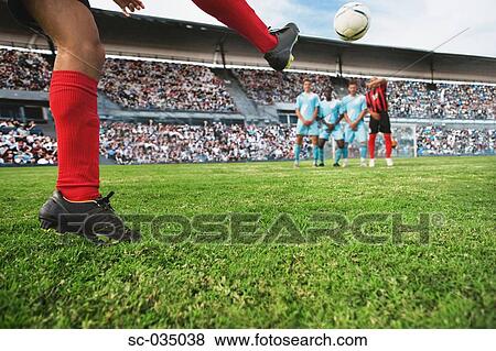 Stock Photo - Soccer player taking a freekick. Fotosearch