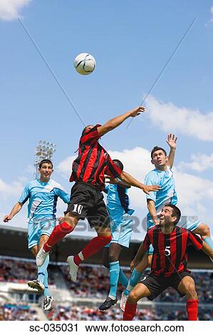 Stock Image - Soccer players jumping for header. Fotosearch