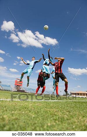 Stock Photo - Soccer players jumping for header. Fotosearch