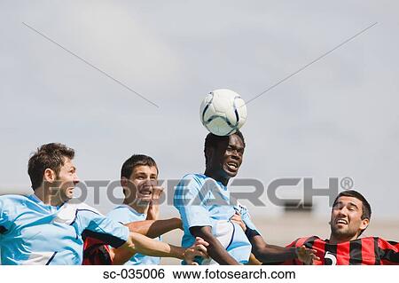 Stock Photograph - Soccer players jumping for header. Fotosearch