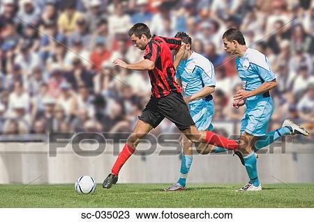 Three soccer players challenging for ball View Large Photo Image Stock Image - Three soccer players challenging for ball. Fotosearch