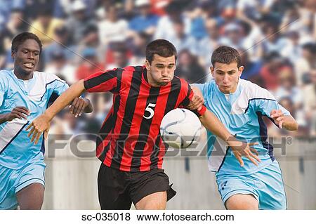 Three soccer players challenging for ball View Large Photo Image Stock Photo - Three soccer players challenging for ball. Fotosearch