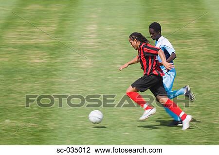 Two soccer players challenging for the ball View Large Photo Image Stock Image - Two soccer players challenging for the ball. Fotosearch