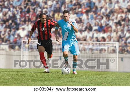 Stock Photo - Two soccer players challenging for the ball. Fotosearch