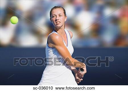 Stock Image - Tennis player hitting backhand return. Fotosearch