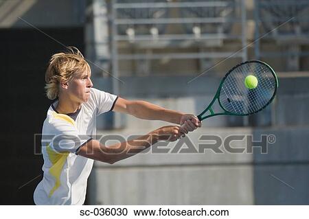 Tennis player hitting backhand return View Large Photo Image Stock Image - Tennis player hitting backhand return. Fotosearch
