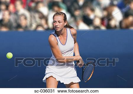 Tennis player hitting backhand return View Large Photo Image Stock Image - Tennis player hitting backhand return. Fotosearch