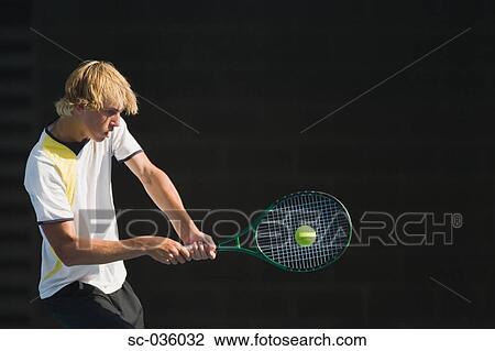 Stock Image - Tennis player hitting backhand return. Fotosearch