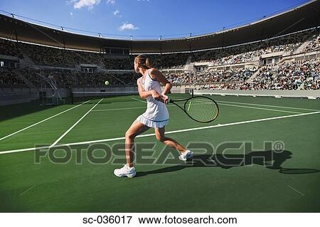 Tennis player hitting backhand return View Large Photo Image Stock Photo - Tennis player hitting backhand return. Fotosearch