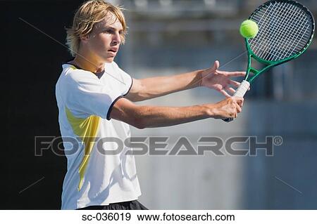 Tennis player hitting backhand return View Large Photo Image Stock Photo - Tennis player hitting backhand return. Fotosearch