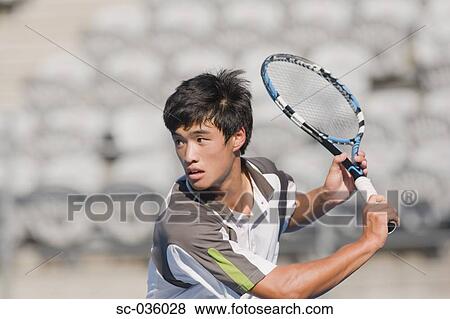 Tennis player hitting backhand return View Large Photo Image Stock Photo - Tennis player hitting backhand return. Fotosearch