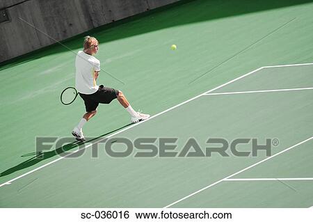 Stock Photograph - Tennis player hitting backhand return. Fotosearch