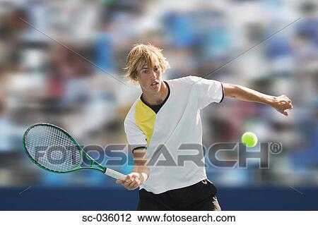 Stock Image - Tennis player hitting forehand return. Fotosearch