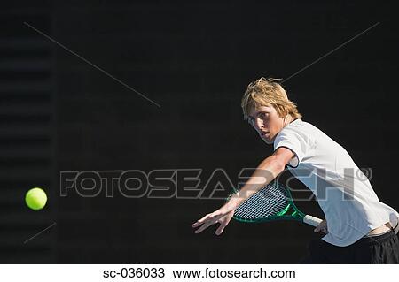 Stock Image - Tennis player hitting forehand return. Fotosearch