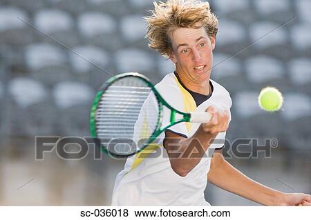 Stock Photo - Tennis player hitting forehand return. Fotosearch