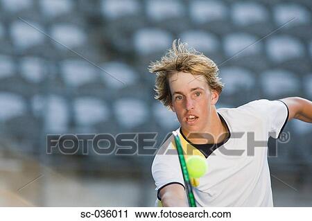 Tennis player reaching for volley View Large Photo Image Stock Image - Tennis player reaching for volley. Fotosearch
