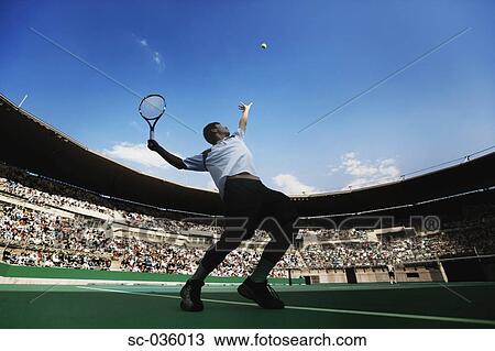 Stock Image - Tennis player serving. Fotosearch